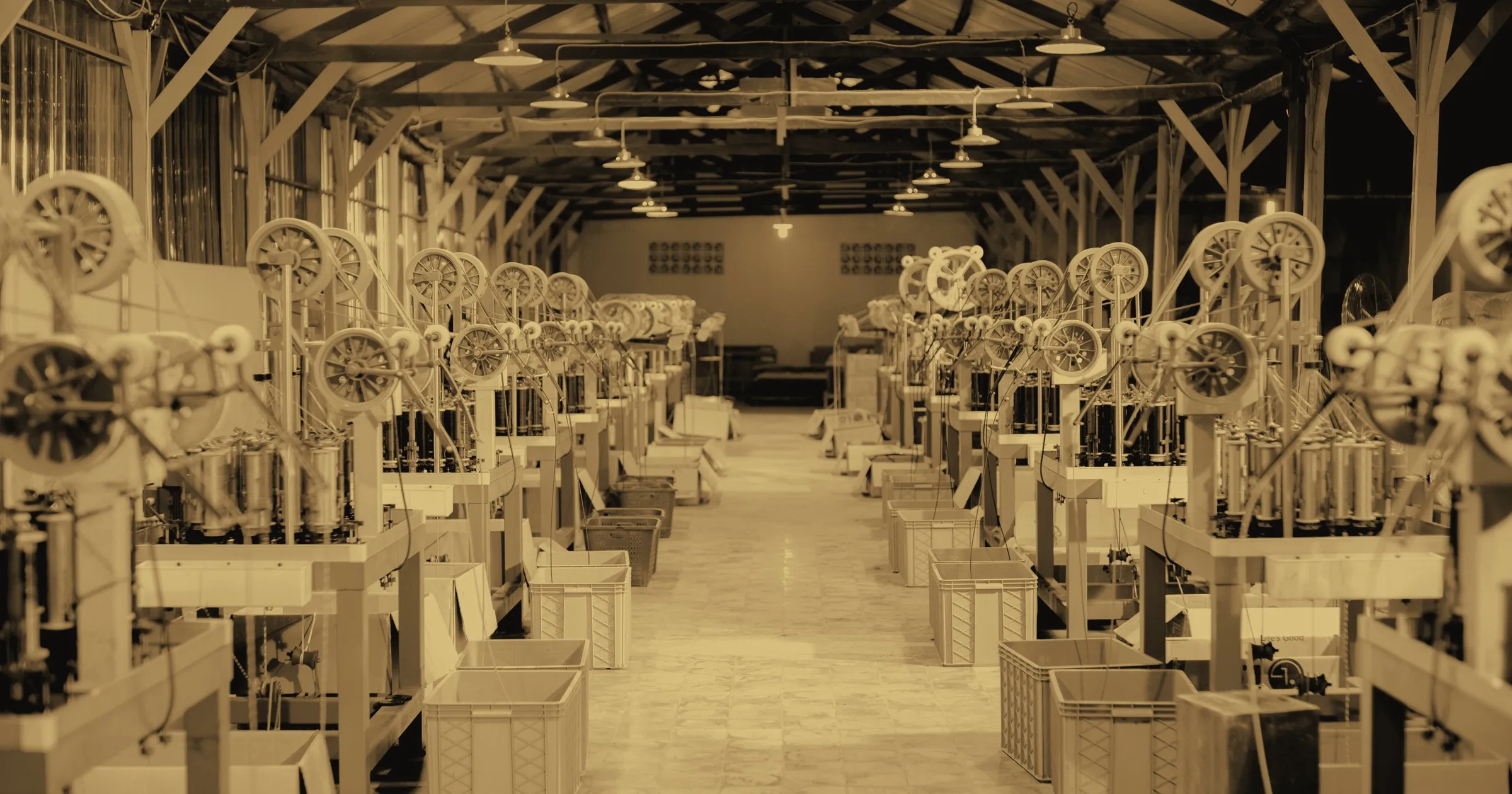 A long factory hall of identical machines in rows