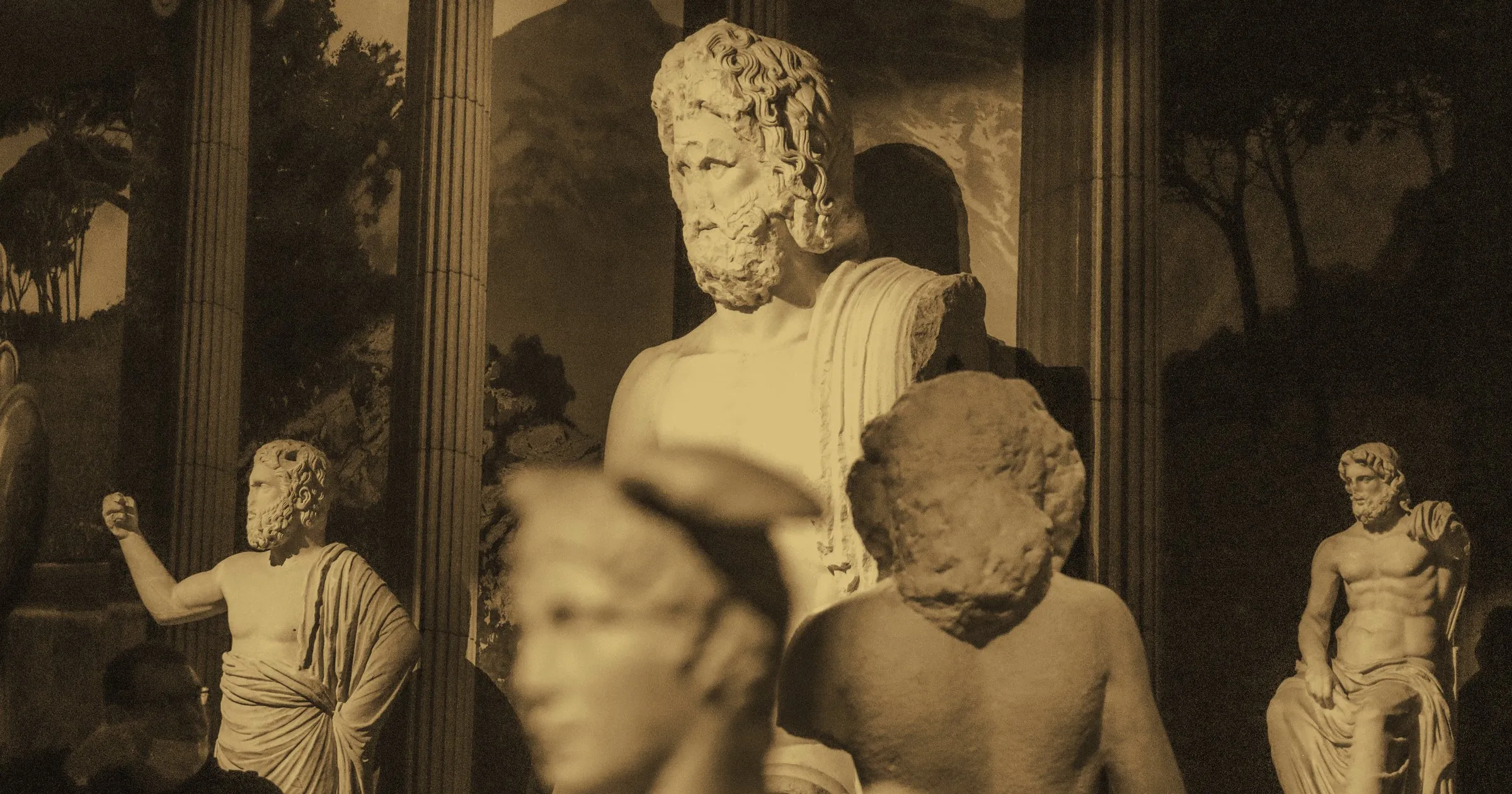 Classical marble busts and statues arranged in a museum gallery