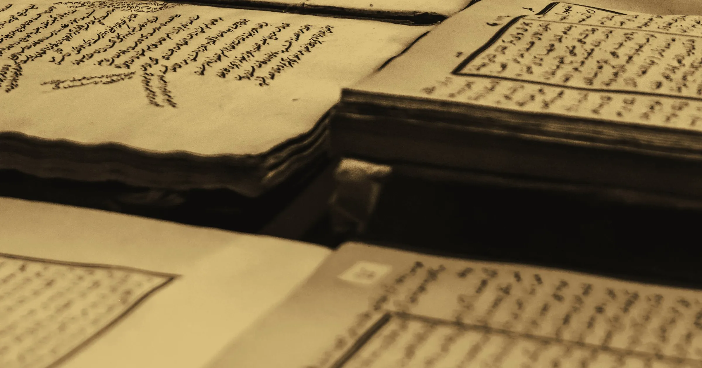 An old manuscript in Arabic script lying open