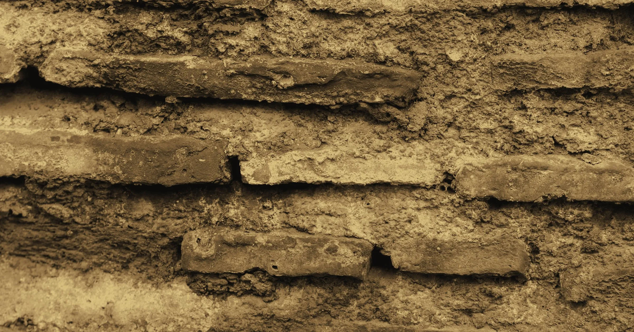 Old, weathered fired bricks laid in courses