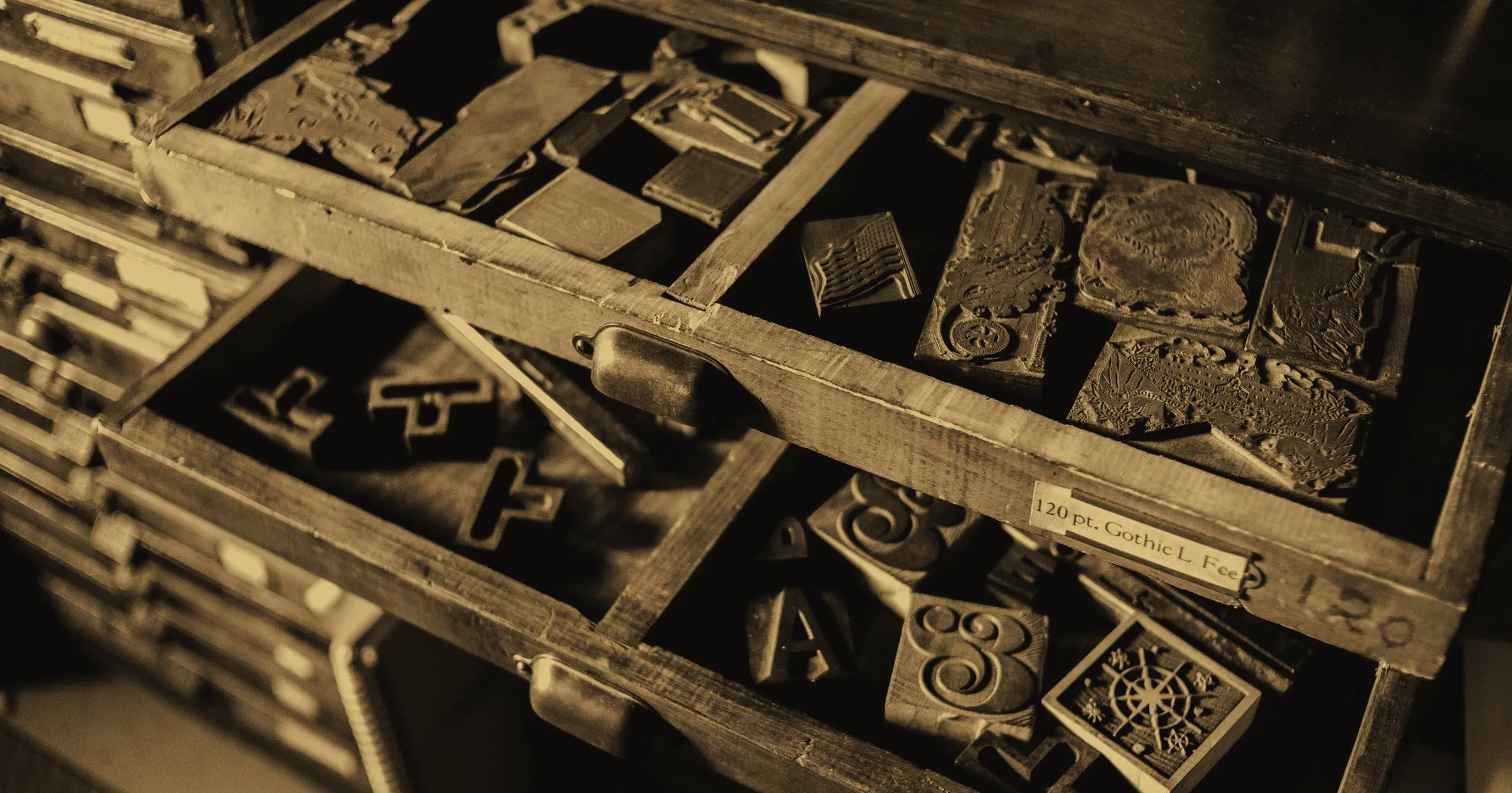 A wooden printer's cabinet of old letterpress type, seen from above