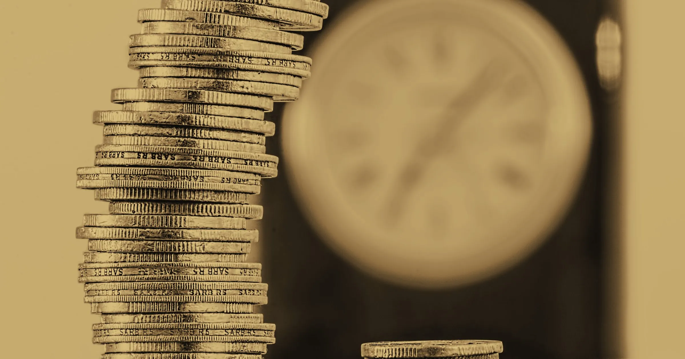 A tall stack of coins beside a clock face