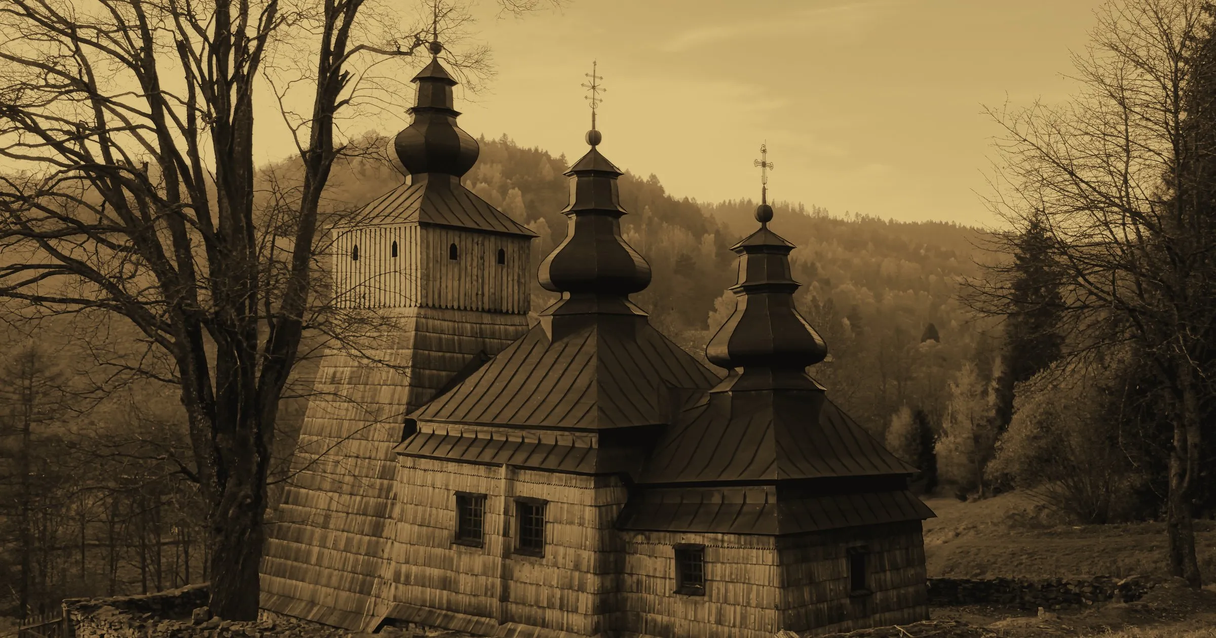 A wooden church with onion domes in a Carpathian forest