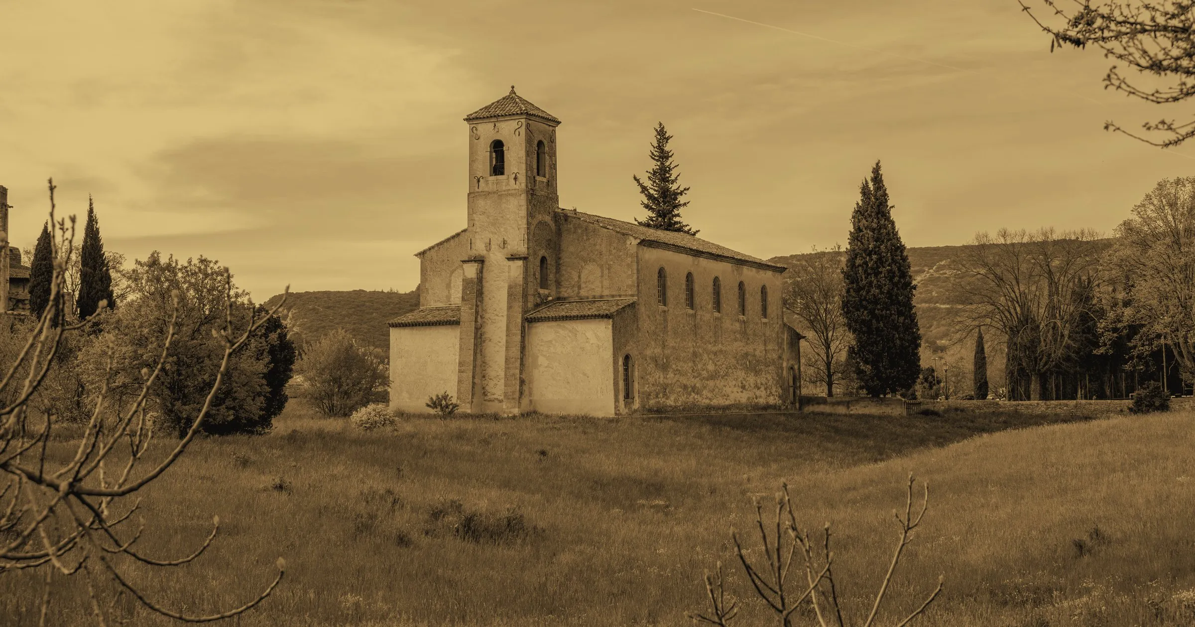 A lone stone church with a bell tower in the French countryside
