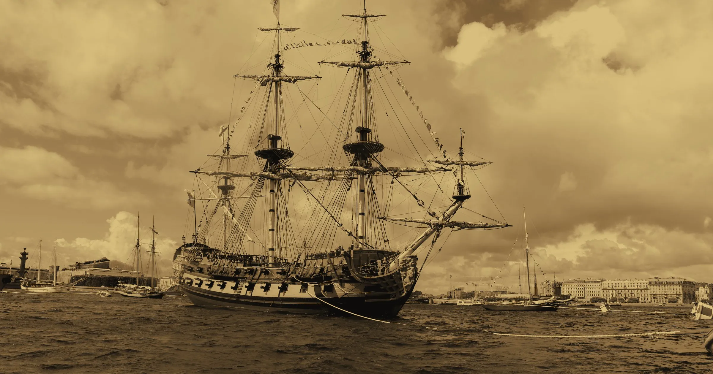 A tall-masted sailing ship of the old European kind at anchor