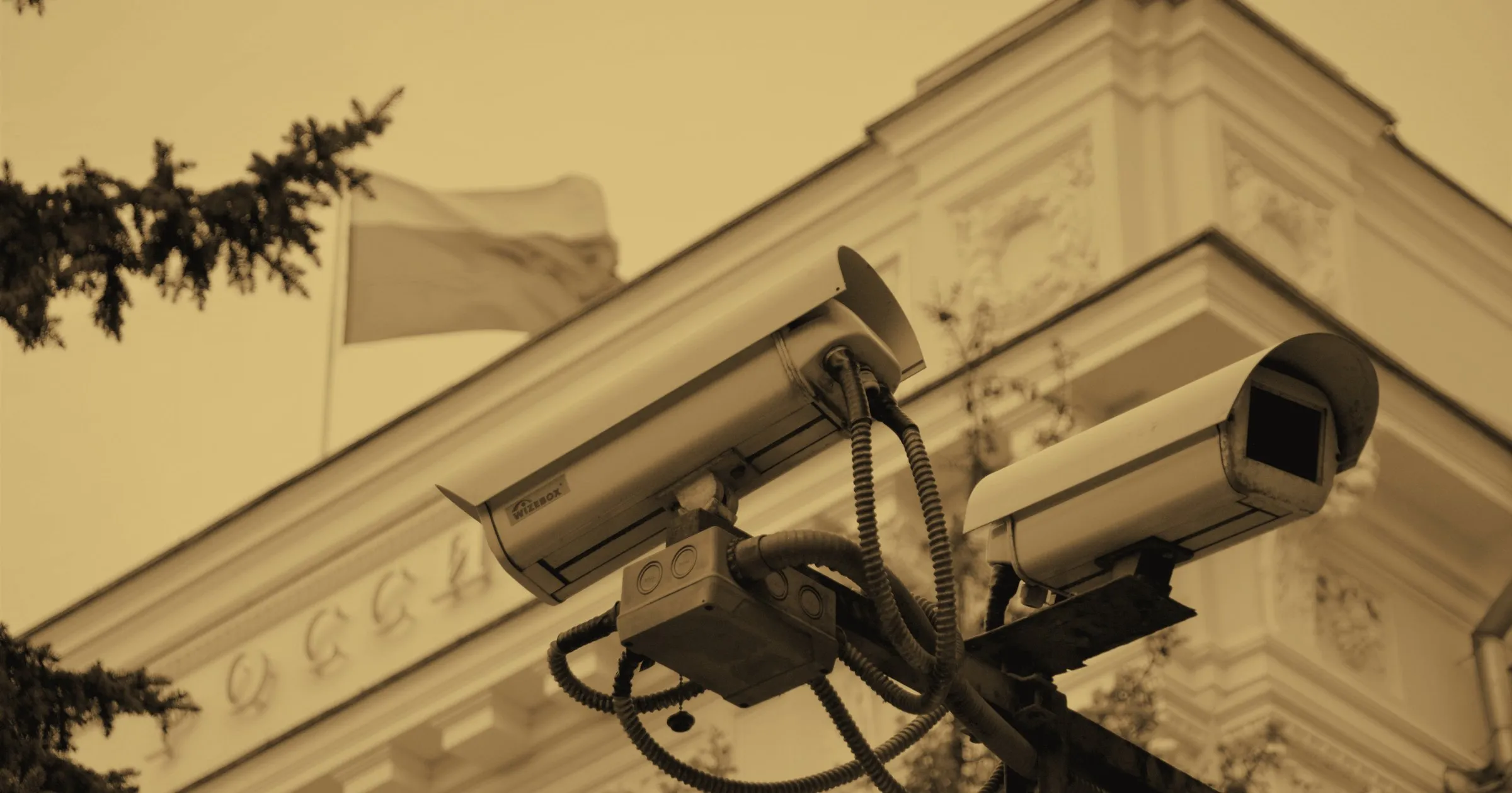 Surveillance cameras mounted on the corner of an ornate European building