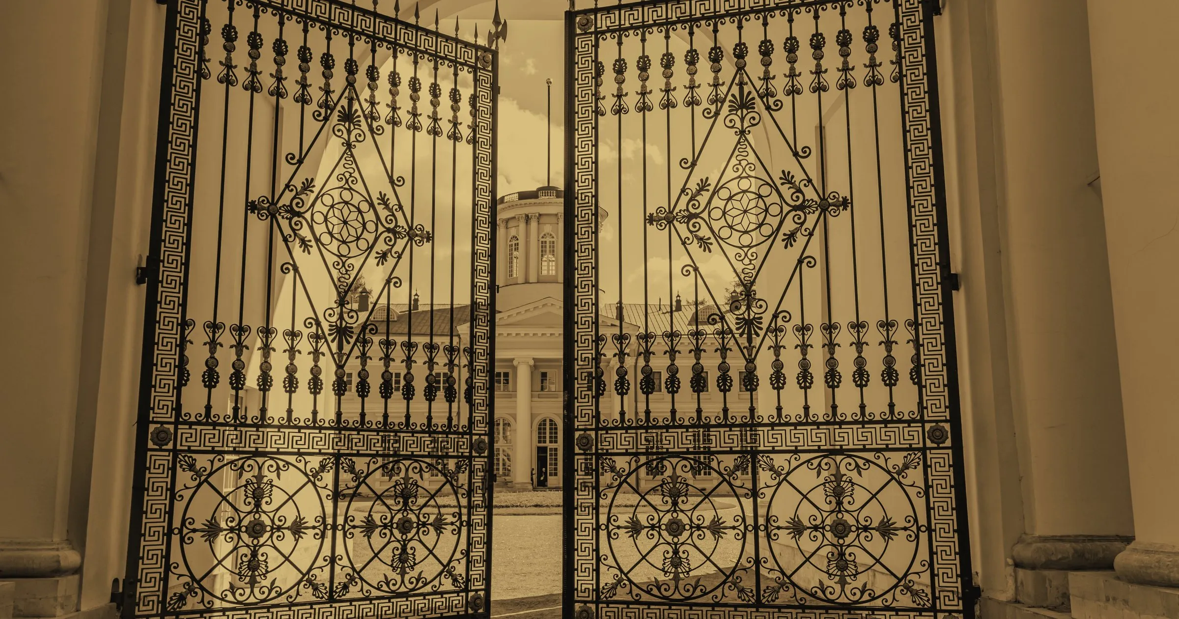 A pair of ornate iron gates standing open