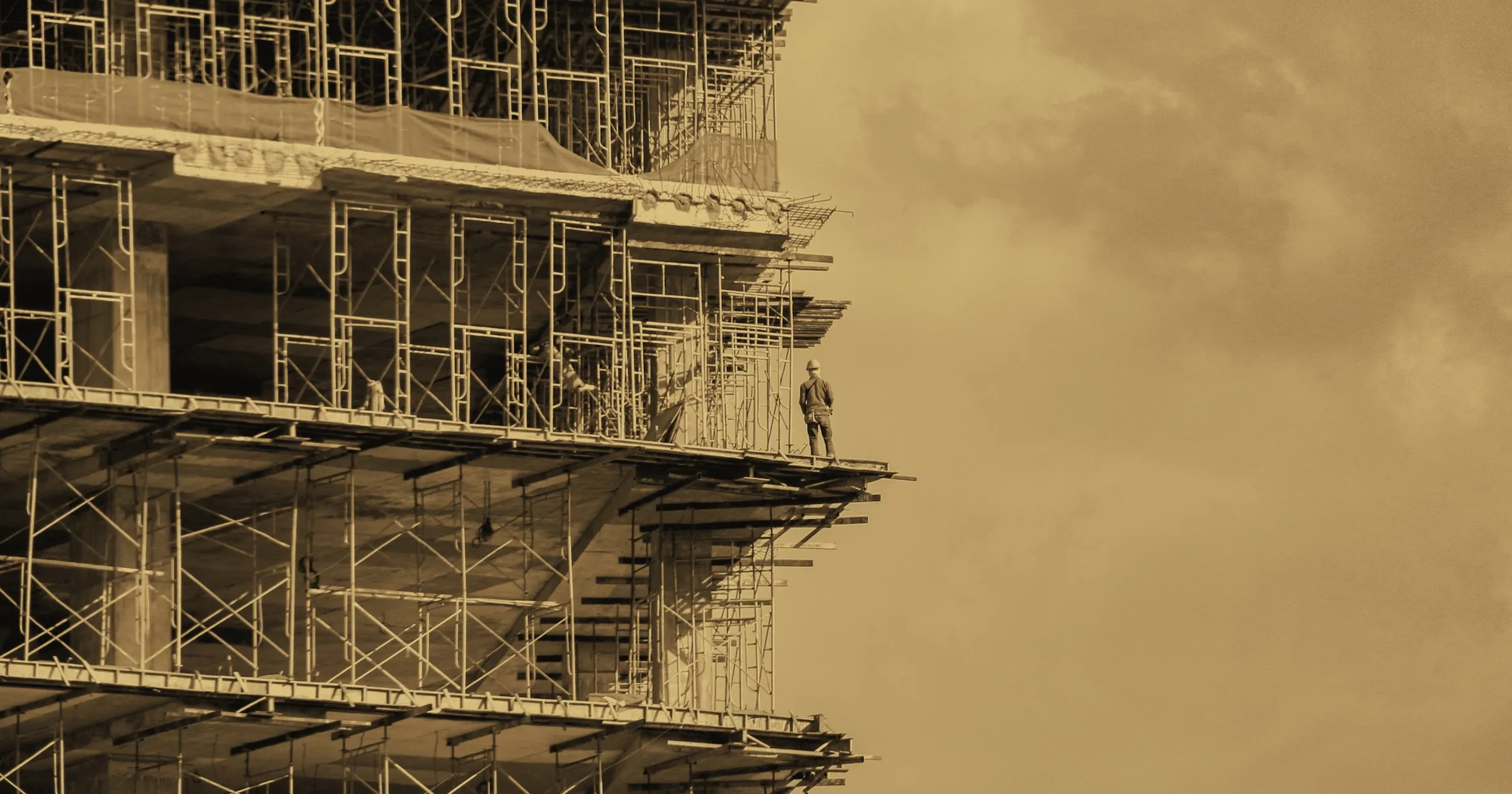 A building under construction, wrapped in scaffolding