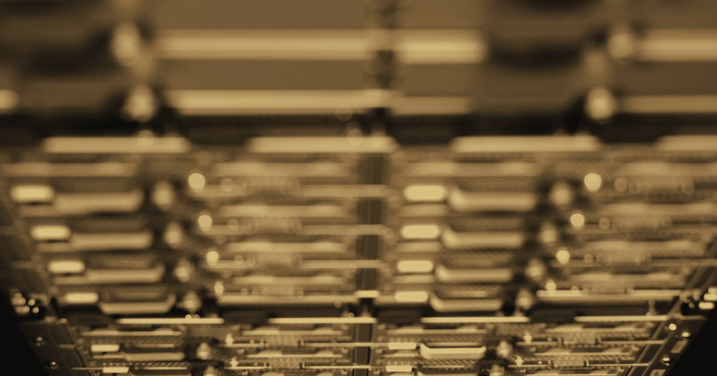 Rows of servers in a data centre, seen from below, their status lights glowing